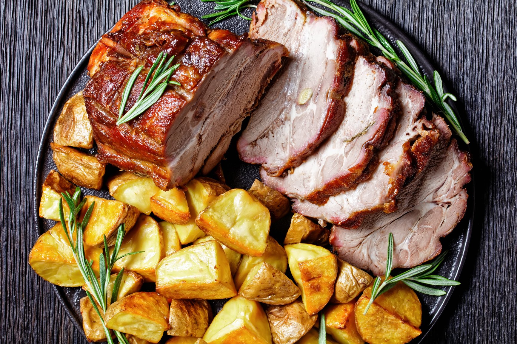 American sunday roast dinner: roasted pork loin with baked potato